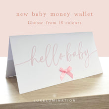 Load image into Gallery viewer, New baby money wallet with 'hello baby' text and pink bow on a light background, featuring the Luxelumination brand.
